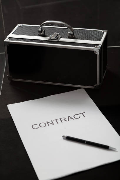 istock Contract and case for money close-up 1269003105