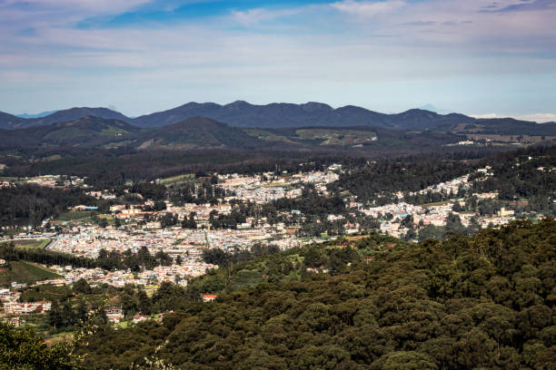 istock city view with mountain range and bright blue sky from hill top at day 1269011136