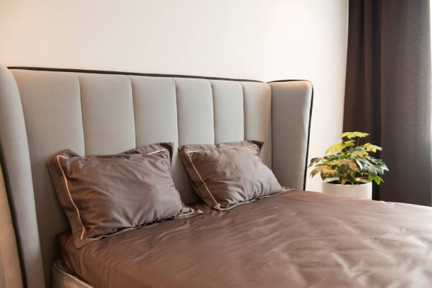 istock Beautiful bedding on a large bed in a king size bedroom 1269015128