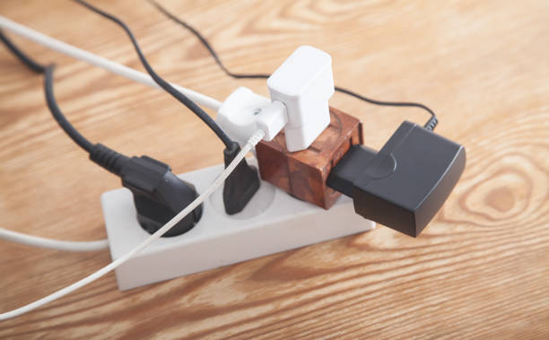 istock Different electrical plugs and chargers connected extension block. 1269016879