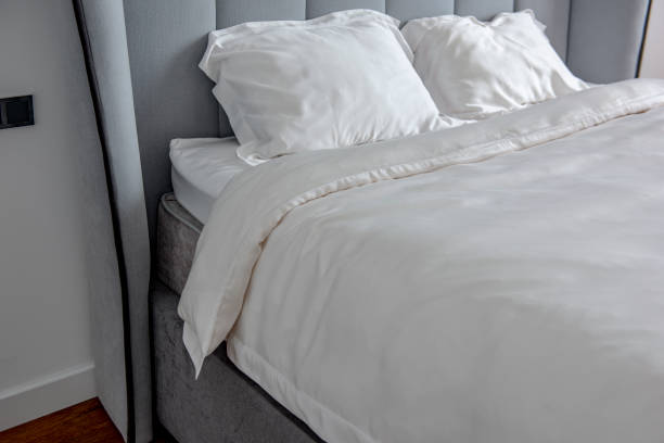 istock Beautiful bedding on a large bed in a king size bedroom 1269017175