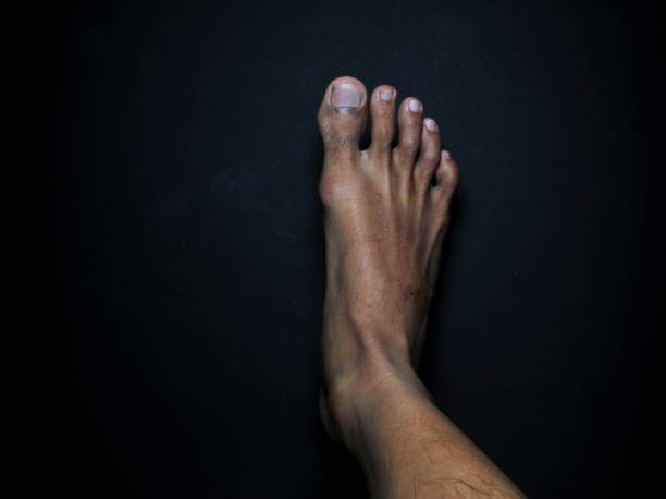 istock Close-up male feet isolated on black background 1269019128