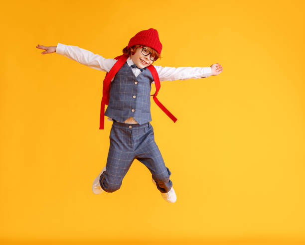 istock Energetic stylish schoolboy leaping up 1269019228