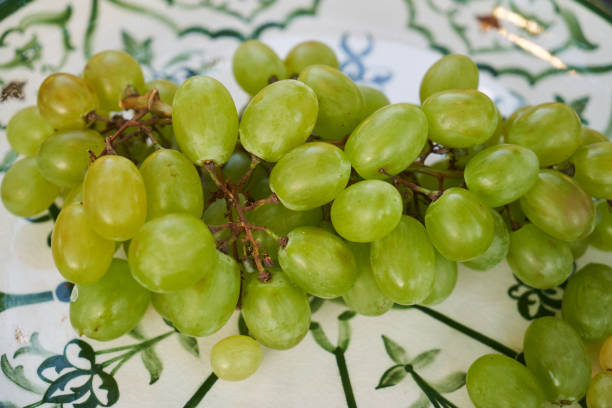 istock Plate with green grapes bunch, close-up. Fresh grape 1269020739