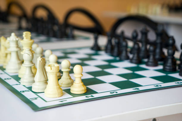 istock chess boards with black and white pieces on the table 1269022375