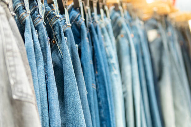 istock Colorful jeans hanging on a hanger in a store 1269027344