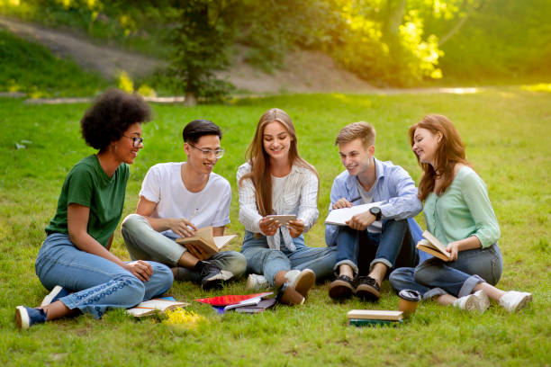 istock Campus Pastime. Joyful college students resting outdoors with smartphone, watching videos 1269029304