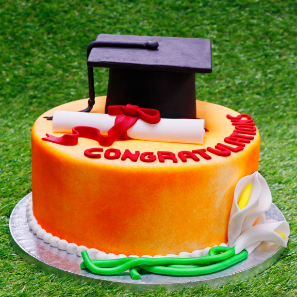 istock graduation cake with green grass background isolated 1269029453