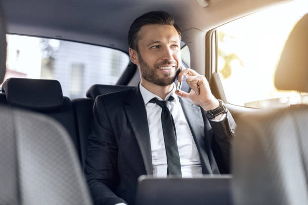 istock Happy successful businessman talking on phone in car 1269029497