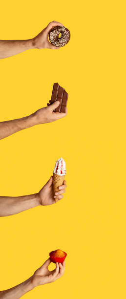 istock Collage with male hands holding different sweets on orange background 1269029756