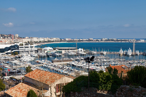 View of the Old Port of Cannes from the hill with the Palais des Festivals and La Rotonde Lérins in the background.