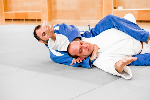 Two Adult Judoists Fighting on the Ground