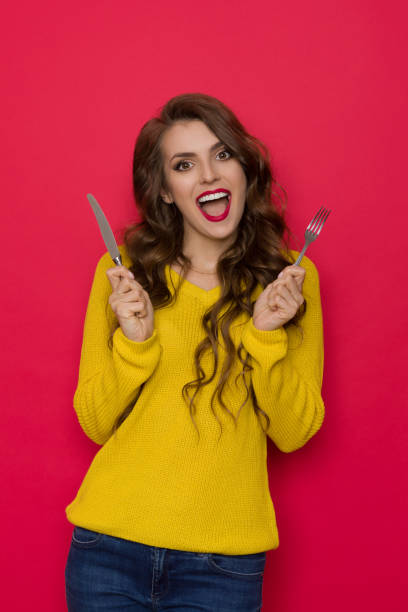 istock Happy Young Woman Holding Knife And Fork And Shouting 1269030211