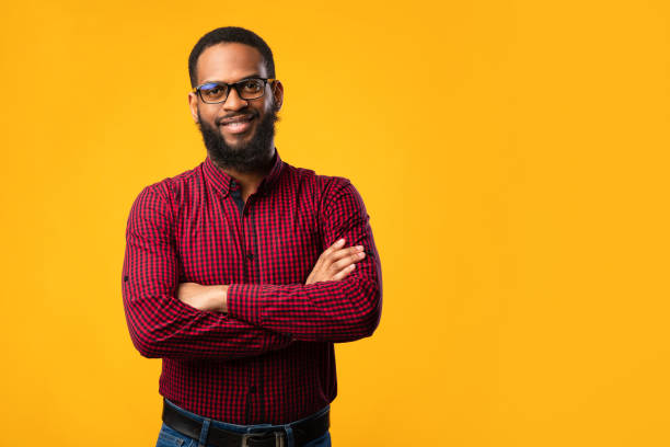 istock Smiling afro man posing on yellow background 1269031030