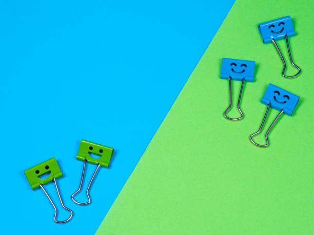 istock Funny smile blue green metal binder clip 1269031656