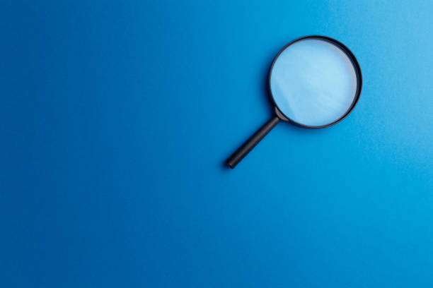 istock Concept information search. Magnifying glass on classic blue background. Top view. Flat lay. Copy space. Minimal creative concept. Trendy color. Searching information data on internet 1269032293
