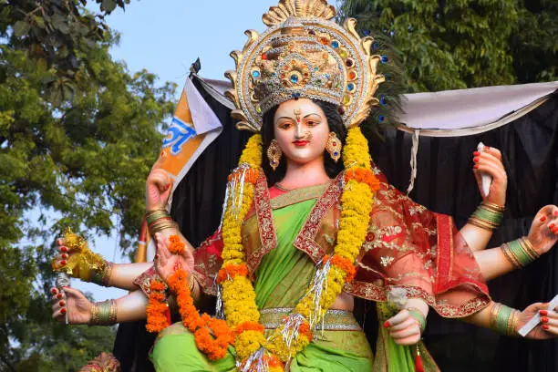 Photo of Sculpture of Hindu Goddess Durga, Goddess Durga idol with ornaments in close up side face view