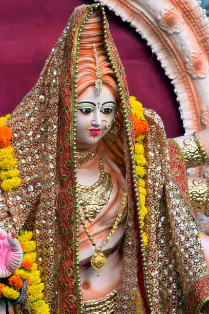 Photo of Sculpture of Hindu Goddess Durga, Goddess Durga idol with ornaments in close up side face view