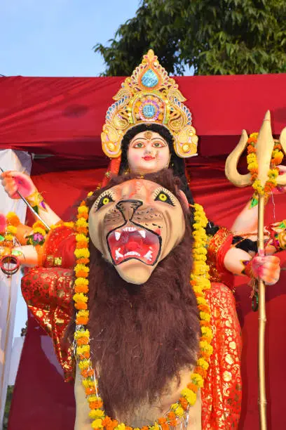 Photo of Sculpture of Hindu Goddess Durga, Goddess Durga idol with ornaments in close up side face view