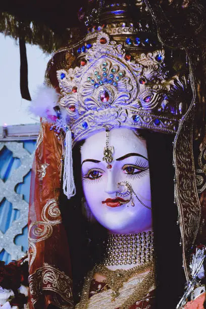 Photo of Sculpture of Hindu Goddess Durga, Goddess Durga idol with ornaments in close up side face view