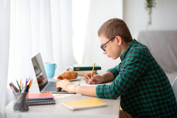 istock Teenager working hard on homework, online education 1269033072