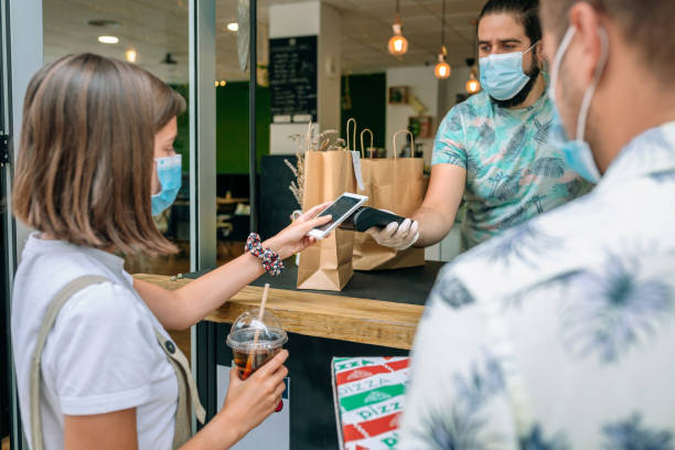 istock Woman paying with mobile a take away order 1269033138