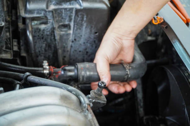 istock mechanic's hand is replacing the upper radiator hoses. 1269033430