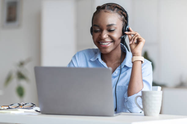 istock Customer Support. Black woman manager wearing headset and using laptop in office 1269034696