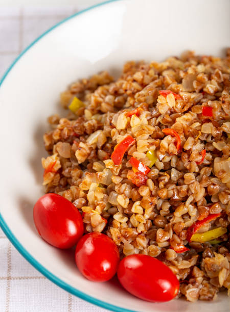 istock Buckwheat pilaf (pilav) with vegetable in dish on wooden background. 1269034706