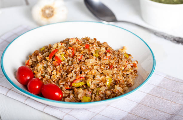 istock Buckwheat pilaf (pilav) with vegetable in dish on wooden background. 1269034773