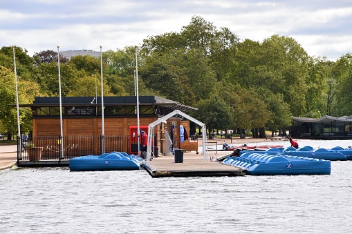 London, United Kingdom - August 26 2020: Blue rental Pedal boats on The Serpentine, Hyde Park