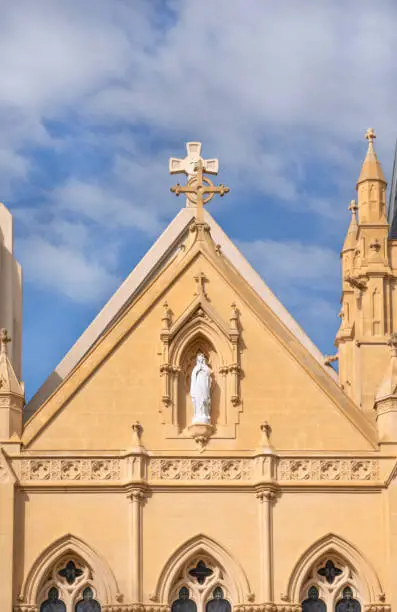 PERTH, WESTERN AUSTRALIA - August, 2020: St Mary's Cathedral. The cathedral church of the Roman Catholic Archdiocese of Perth. Officially is the Cathedral of the Immaculate Conception of the Blessed Virgin Mary. View to the Saint Mary sculpture from the main entrance.