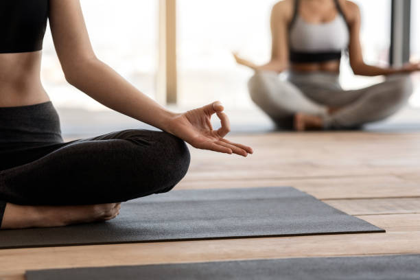 istock Closeup Of Unrecognizable Female Practicing Yoga At Group Class In Studio 1269036194