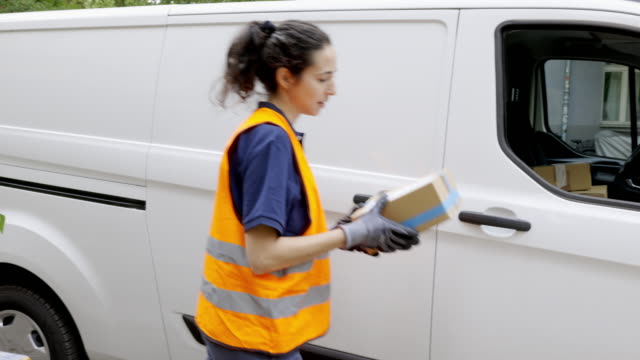 Woman goes on delivering postal parcel