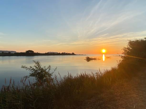 istock Orange sun rising on a river end landscape on a clear sky 1269045512