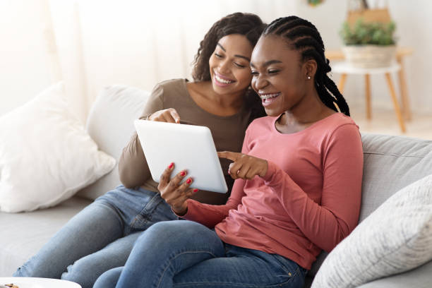 istock African young women using digital tablet together 1269045564