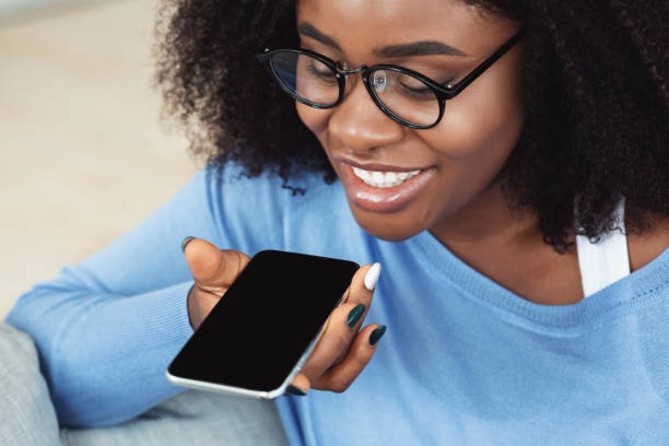 istock Young woman using voice assistant on smartphone 1269047527