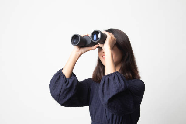 istock Young Asian woman with binoculars. 1269047627