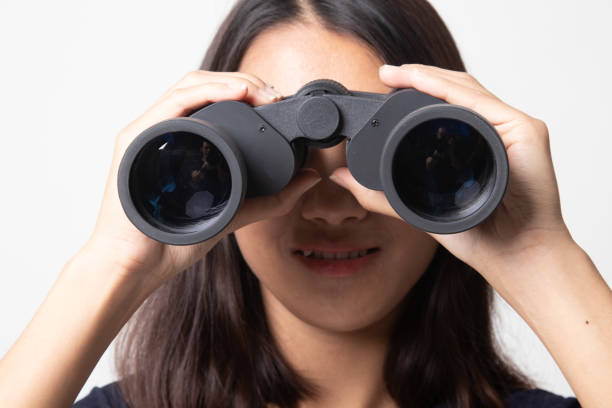 istock Young Asian woman with binoculars. 1269047645