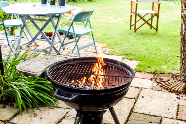 istock Bbq grill with flames in an empty back garden preparing to cook outside 1269047688