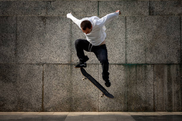 istock Young man doing tricks on his skateboard in the city 1269047884