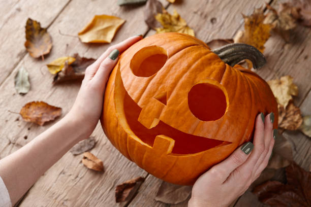 istock Woman holding Halloween pumpkin jack 1269048613