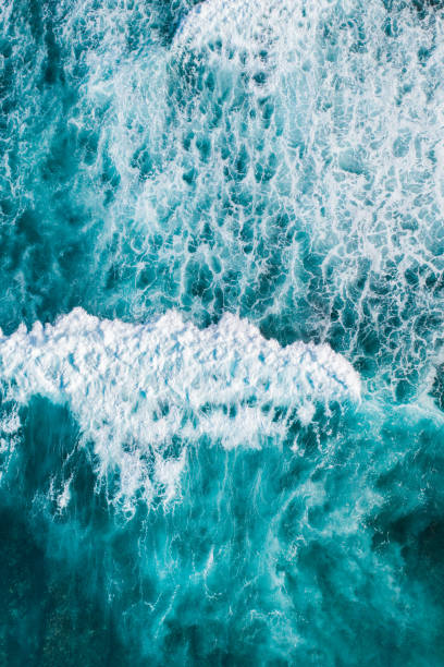 istock Big ocean waves hitting a coral reef. View from above. 1269050152
