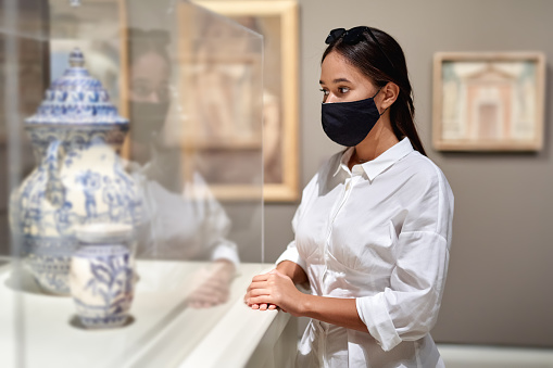 visitor looking art object in museum