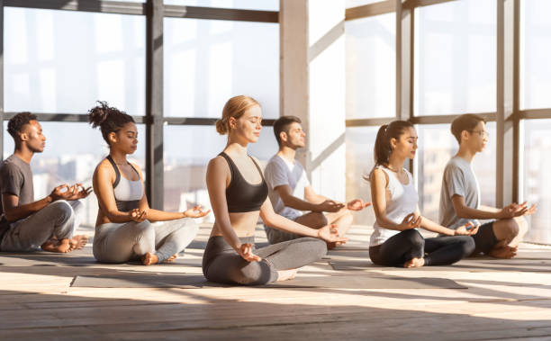 istock Group Yoga Practice. Relaxed Multiracial People Meditating With Closed Eyes In Studio 1269057750