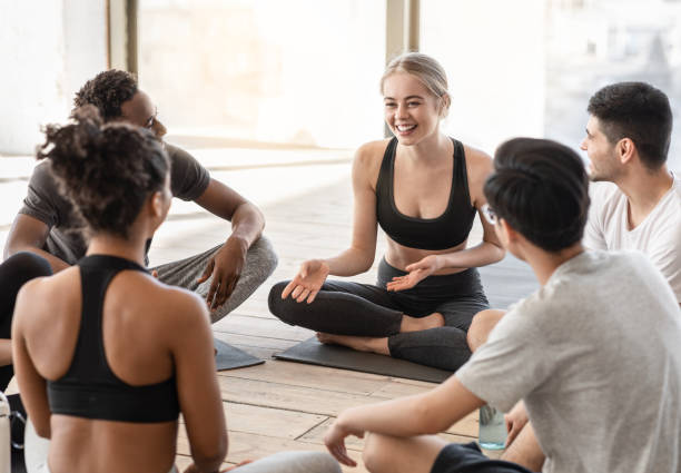 istock Milti-ethnic group of sporty people chatting and laughing before training in studio 1269057775
