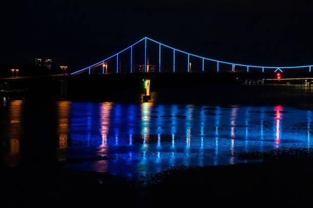 istock Night view of a beautiful multi-colored illumination on the bridge. Reflection in the river 1269057784