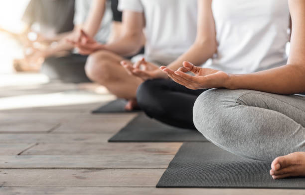 istock Group Of Unrecognizable People Meditating In Lotus Position And Showing Mudra Gestures 1269058321