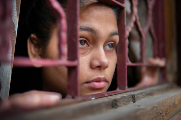istock sad young girl looking out through the window and thinking. 1269062786