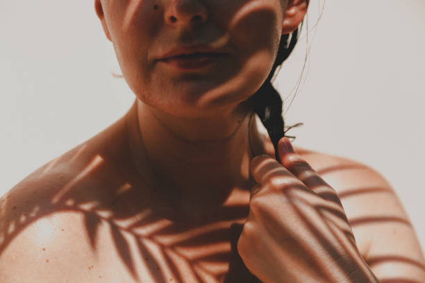 istock Shadow from palm tree falls on  girl naked body 1269064042